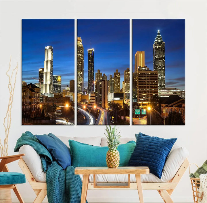 A modern living room is enhanced by the "Atlanta Cityscape View Wall Art Canvas Print" displayed as a triptych on museum-quality canvas. The hand-assembled framed art adds sophistication, crafting an inviting atmosphere. Complete your stylish space effortlessly with free shipping.