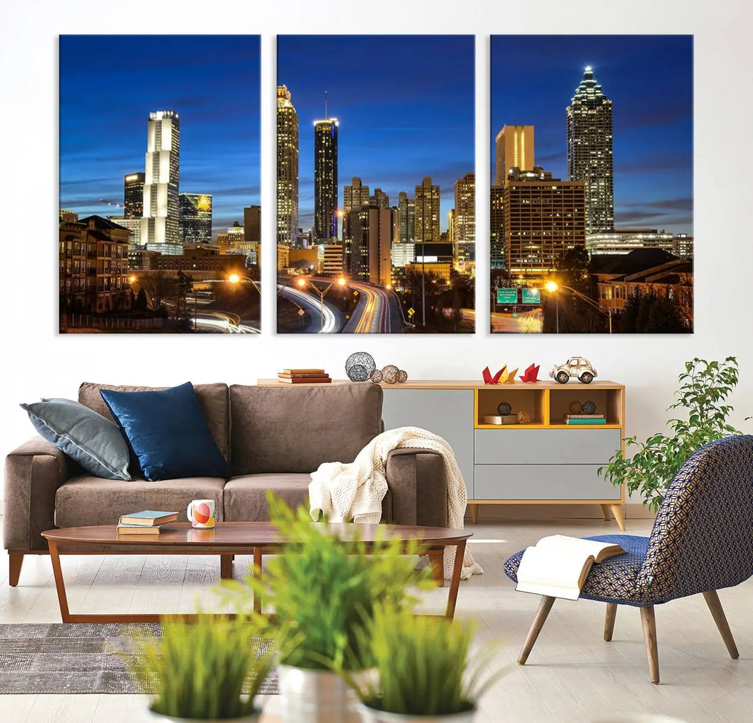 A modern living room is enhanced by the "Atlanta Cityscape View Wall Art Canvas Print" displayed as a triptych on museum-quality canvas. The hand-assembled framed art adds sophistication, crafting an inviting atmosphere. Complete your stylish space effortlessly with free shipping.