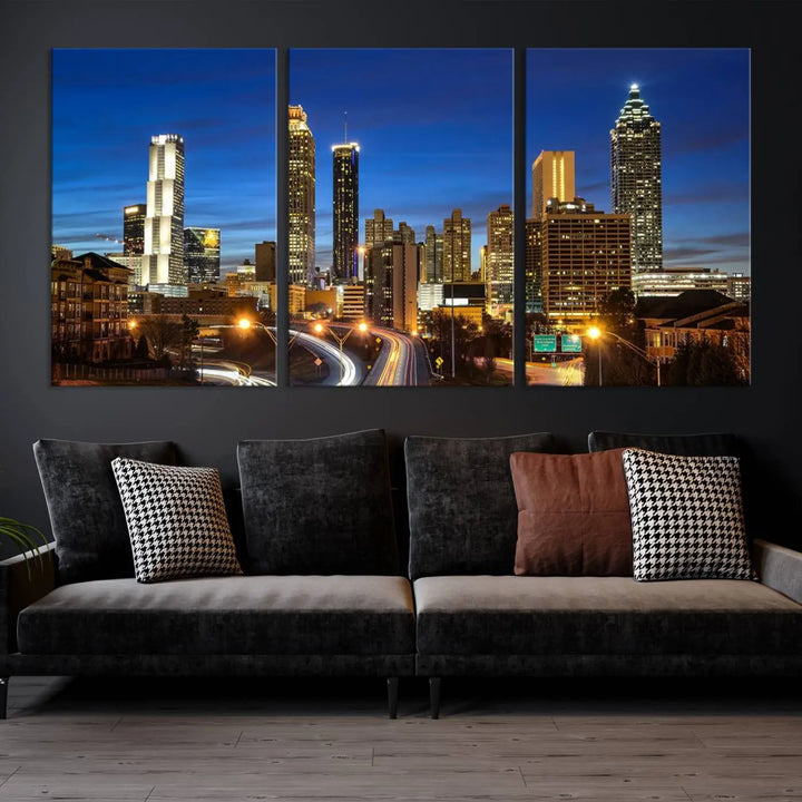 A modern living room is enhanced by the "Atlanta Cityscape View Wall Art Canvas Print" displayed as a triptych on museum-quality canvas. The hand-assembled framed art adds sophistication, crafting an inviting atmosphere. Complete your stylish space effortlessly with free shipping.