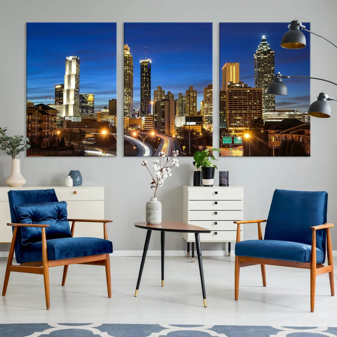 A modern living room is enhanced by the "Atlanta Cityscape View Wall Art Canvas Print" displayed as a triptych on museum-quality canvas. The hand-assembled framed art adds sophistication, crafting an inviting atmosphere. Complete your stylish space effortlessly with free shipping.