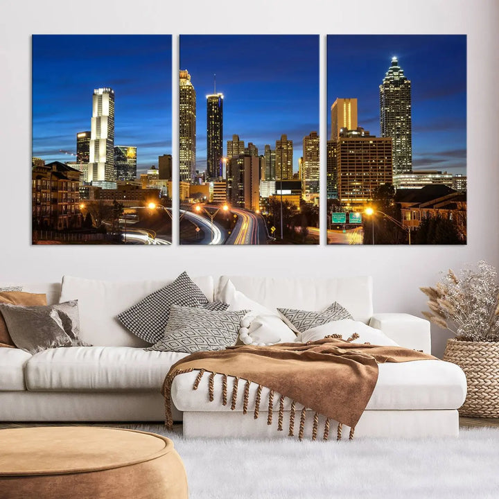 A modern living room is enhanced by the "Atlanta Cityscape View Wall Art Canvas Print" displayed as a triptych on museum-quality canvas. The hand-assembled framed art adds sophistication, crafting an inviting atmosphere. Complete your stylish space effortlessly with free shipping.