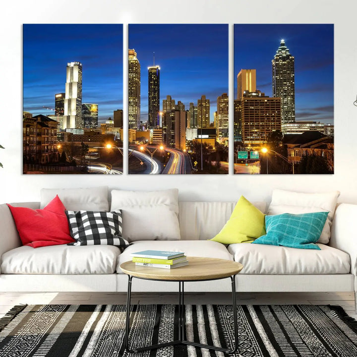 A modern living room is enhanced by the "Atlanta Cityscape View Wall Art Canvas Print" displayed as a triptych on museum-quality canvas. The hand-assembled framed art adds sophistication, crafting an inviting atmosphere. Complete your stylish space effortlessly with free shipping.