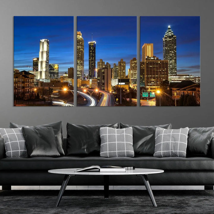 A modern living room is enhanced by the "Atlanta Cityscape View Wall Art Canvas Print" displayed as a triptych on museum-quality canvas. The hand-assembled framed art adds sophistication, crafting an inviting atmosphere. Complete your stylish space effortlessly with free shipping.