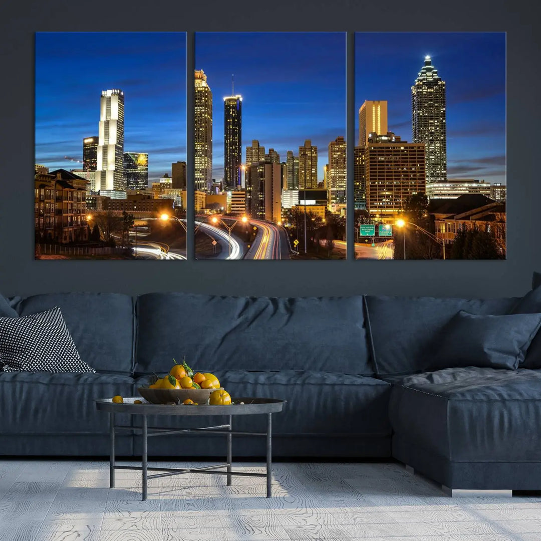 A modern living room is enhanced by the "Atlanta Cityscape View Wall Art Canvas Print" displayed as a triptych on museum-quality canvas. The hand-assembled framed art adds sophistication, crafting an inviting atmosphere. Complete your stylish space effortlessly with free shipping.