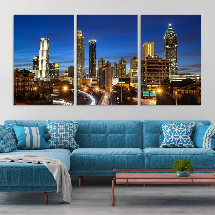 A modern living room is enhanced by the "Atlanta Cityscape View Wall Art Canvas Print" displayed as a triptych on museum-quality canvas. The hand-assembled framed art adds sophistication, crafting an inviting atmosphere. Complete your stylish space effortlessly with free shipping.