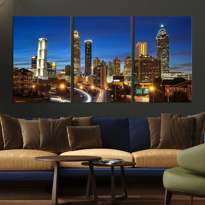 A modern living room is enhanced by the "Atlanta Cityscape View Wall Art Canvas Print" displayed as a triptych on museum-quality canvas. The hand-assembled framed art adds sophistication, crafting an inviting atmosphere. Complete your stylish space effortlessly with free shipping.