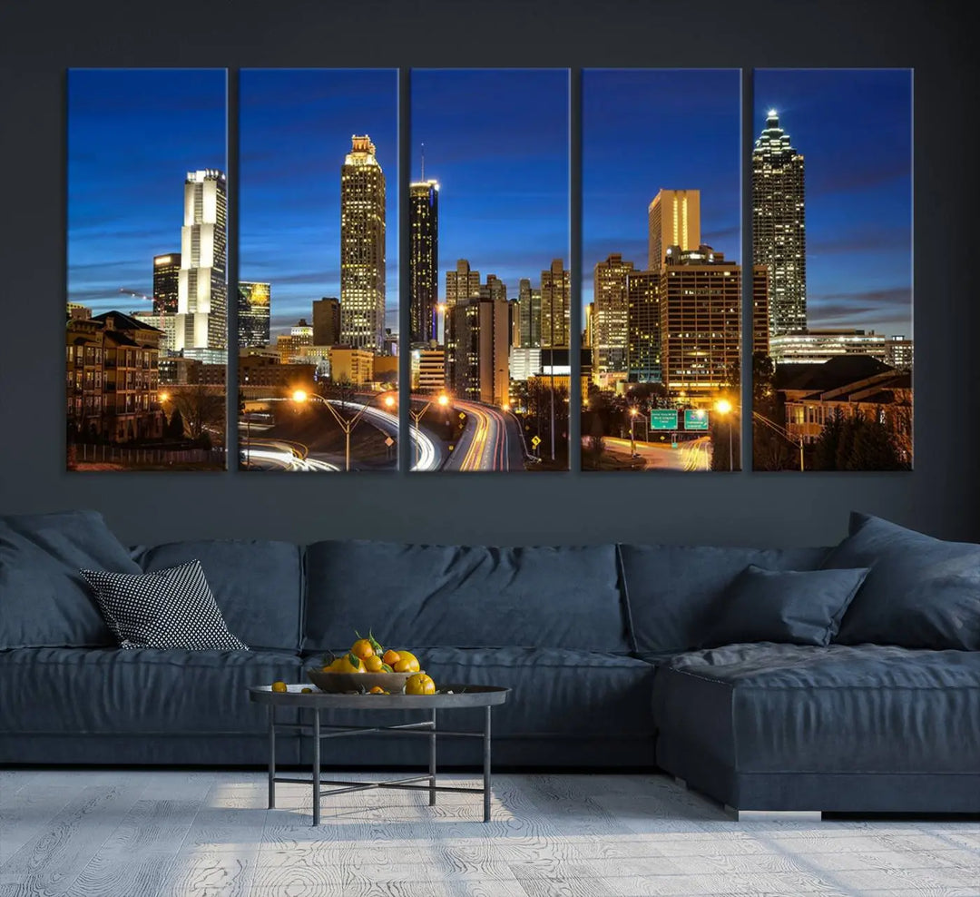 A modern living room is enhanced by the "Atlanta Cityscape View Wall Art Canvas Print" displayed as a triptych on museum-quality canvas. The hand-assembled framed art adds sophistication, crafting an inviting atmosphere. Complete your stylish space effortlessly with free shipping.