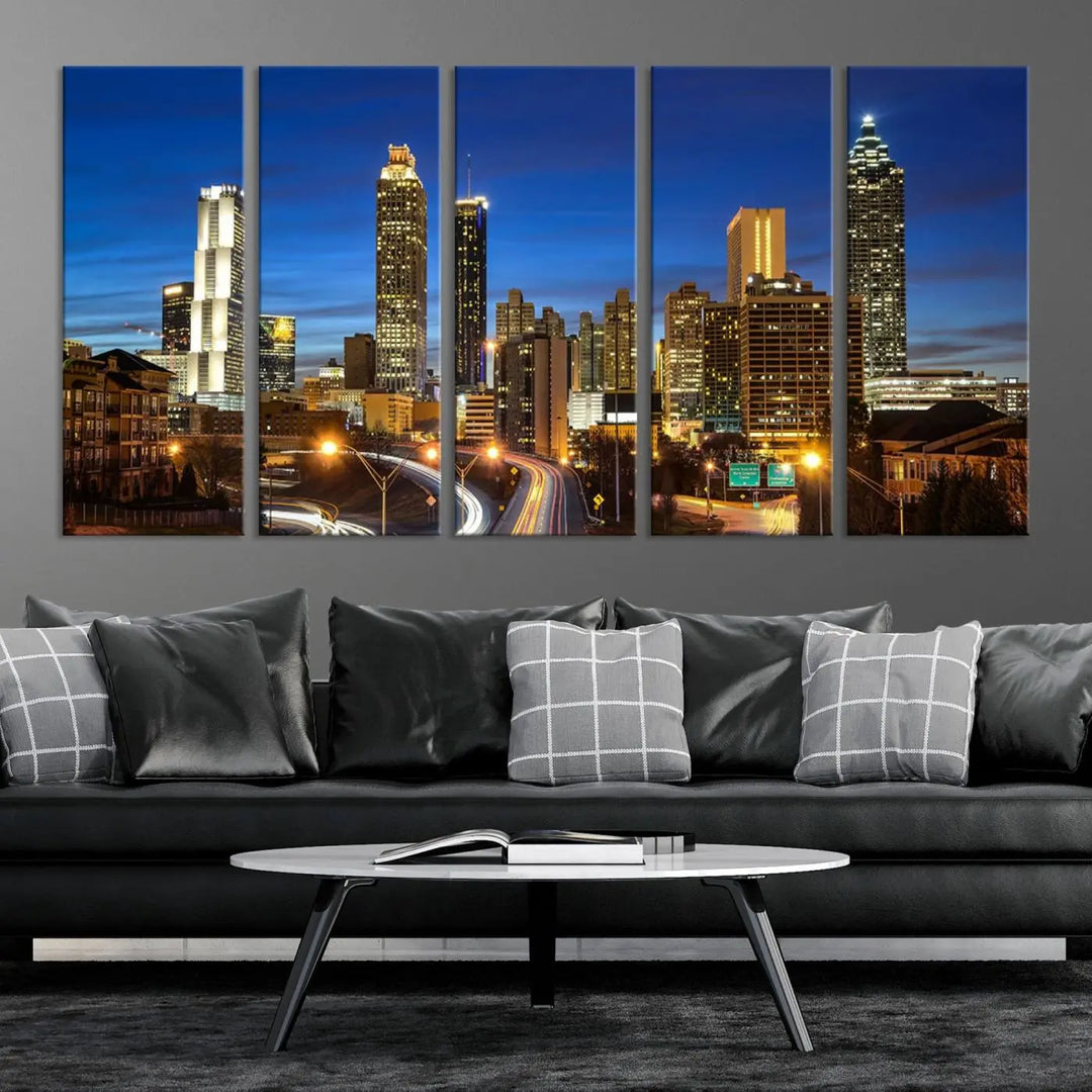 A modern living room is enhanced by the "Atlanta Cityscape View Wall Art Canvas Print" displayed as a triptych on museum-quality canvas. The hand-assembled framed art adds sophistication, crafting an inviting atmosphere. Complete your stylish space effortlessly with free shipping.