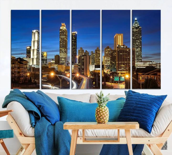 A modern living room is enhanced by the "Atlanta Cityscape View Wall Art Canvas Print" displayed as a triptych on museum-quality canvas. The hand-assembled framed art adds sophistication, crafting an inviting atmosphere. Complete your stylish space effortlessly with free shipping.