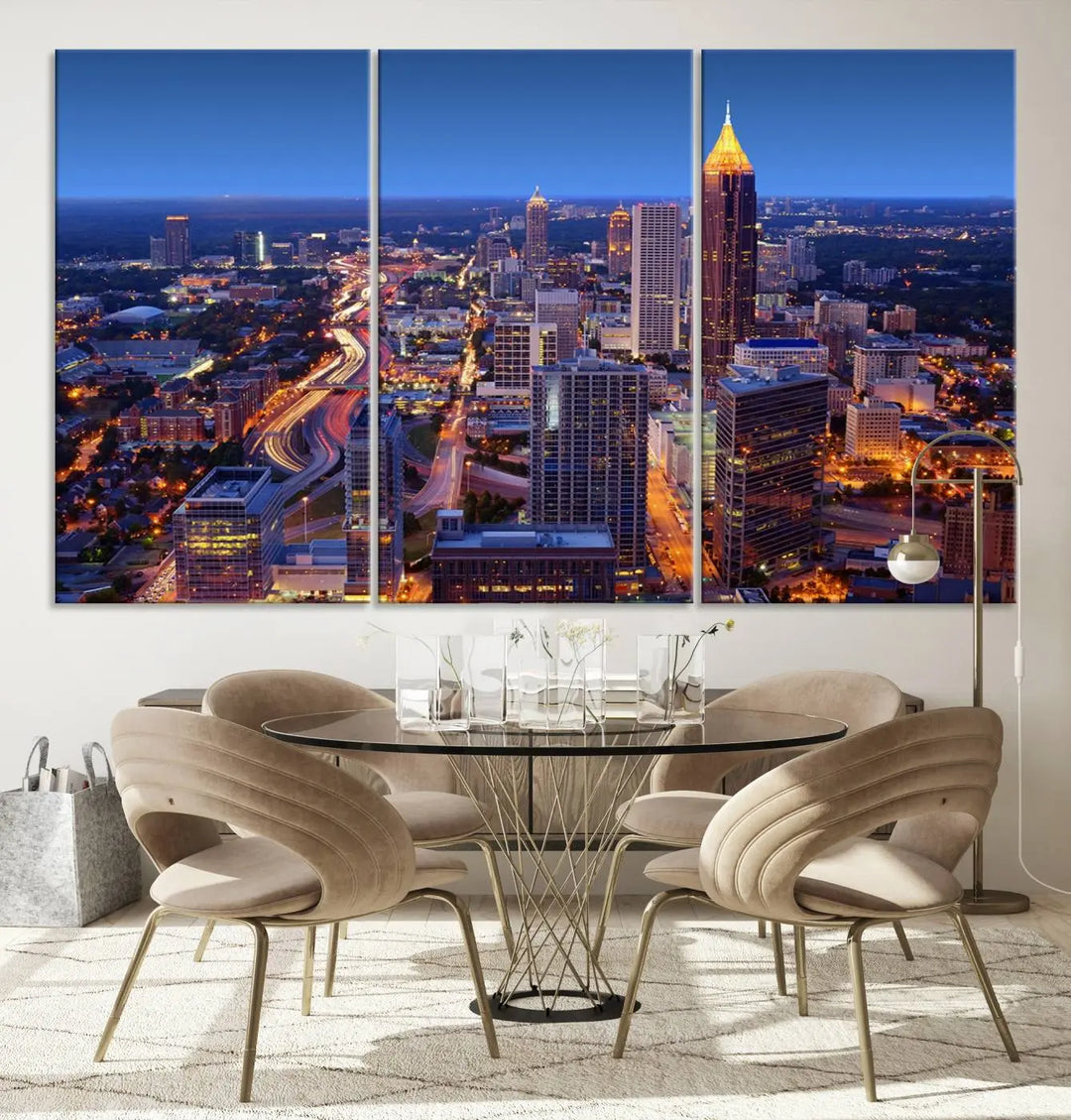 The triptych titled "Atlanta Wall Art Canvas Print" decorates the wall in a modern living room. This museum-quality artwork of a cityscape at night is ready to hang and features a UV-protective coating that ensures lasting vibrancy and elegance.