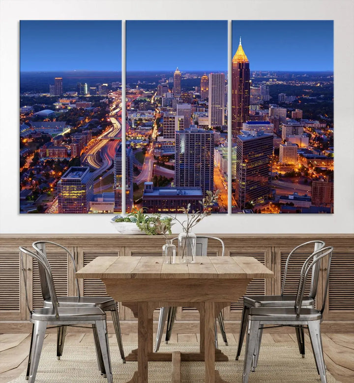 The triptych titled "Atlanta Wall Art Canvas Print" decorates the wall in a modern living room. This museum-quality artwork of a cityscape at night is ready to hang and features a UV-protective coating that ensures lasting vibrancy and elegance.