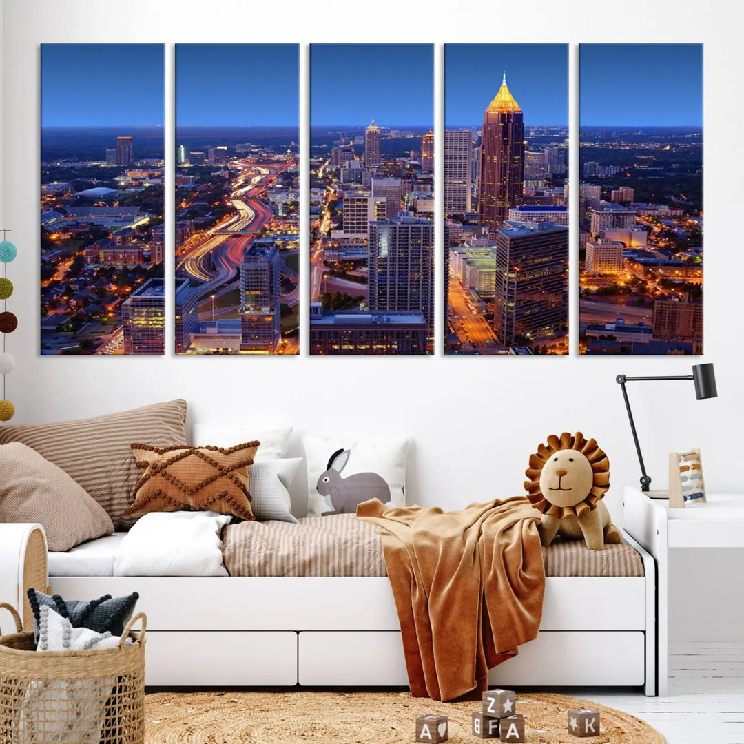 The triptych titled "Atlanta Wall Art Canvas Print" decorates the wall in a modern living room. This museum-quality artwork of a cityscape at night is ready to hang and features a UV-protective coating that ensures lasting vibrancy and elegance.