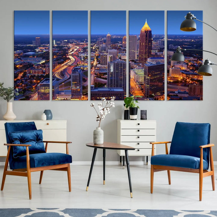 The triptych titled "Atlanta Wall Art Canvas Print" decorates the wall in a modern living room. This museum-quality artwork of a cityscape at night is ready to hang and features a UV-protective coating that ensures lasting vibrancy and elegance.