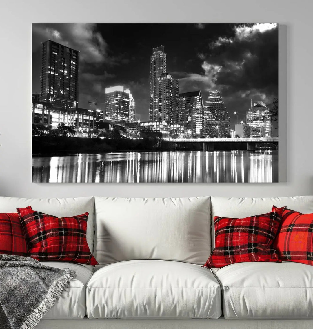 The Austin City Lights Cloudy Skyline Black and White Wall Art Cityscape Canvas Print is a large triptych that showcases illuminated city buildings reflected in water at night. This artwork is produced on museum-quality canvases with a UV-protective coating, ensuring its vibrancy and longevity for years to come.