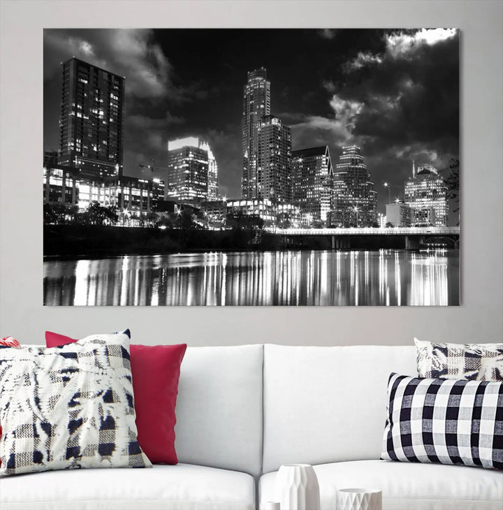 The Austin City Lights Cloudy Skyline Black and White Wall Art Cityscape Canvas Print is a large triptych that showcases illuminated city buildings reflected in water at night. This artwork is produced on museum-quality canvases with a UV-protective coating, ensuring its vibrancy and longevity for years to come.