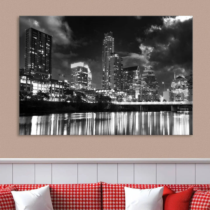 The Austin City Lights Cloudy Skyline Black and White Wall Art Cityscape Canvas Print is a large triptych that showcases illuminated city buildings reflected in water at night. This artwork is produced on museum-quality canvases with a UV-protective coating, ensuring its vibrancy and longevity for years to come.