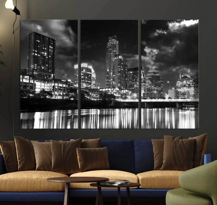 The Austin City Lights Cloudy Skyline Black and White Wall Art Cityscape Canvas Print is a large triptych that showcases illuminated city buildings reflected in water at night. This artwork is produced on museum-quality canvases with a UV-protective coating, ensuring its vibrancy and longevity for years to come.