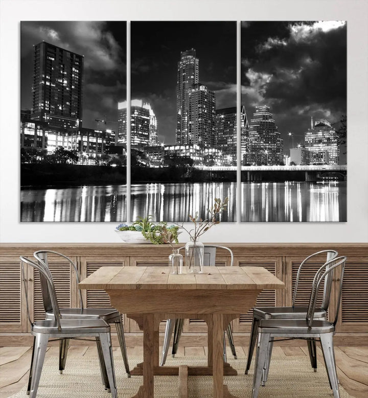 The Austin City Lights Cloudy Skyline Black and White Wall Art Cityscape Canvas Print is a large triptych that showcases illuminated city buildings reflected in water at night. This artwork is produced on museum-quality canvases with a UV-protective coating, ensuring its vibrancy and longevity for years to come.