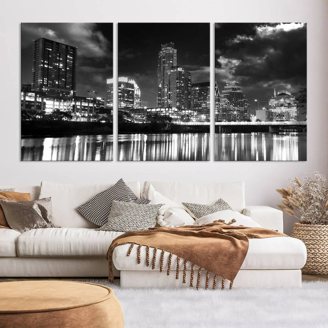 The Austin City Lights Cloudy Skyline Black and White Wall Art Cityscape Canvas Print is a large triptych that showcases illuminated city buildings reflected in water at night. This artwork is produced on museum-quality canvases with a UV-protective coating, ensuring its vibrancy and longevity for years to come.