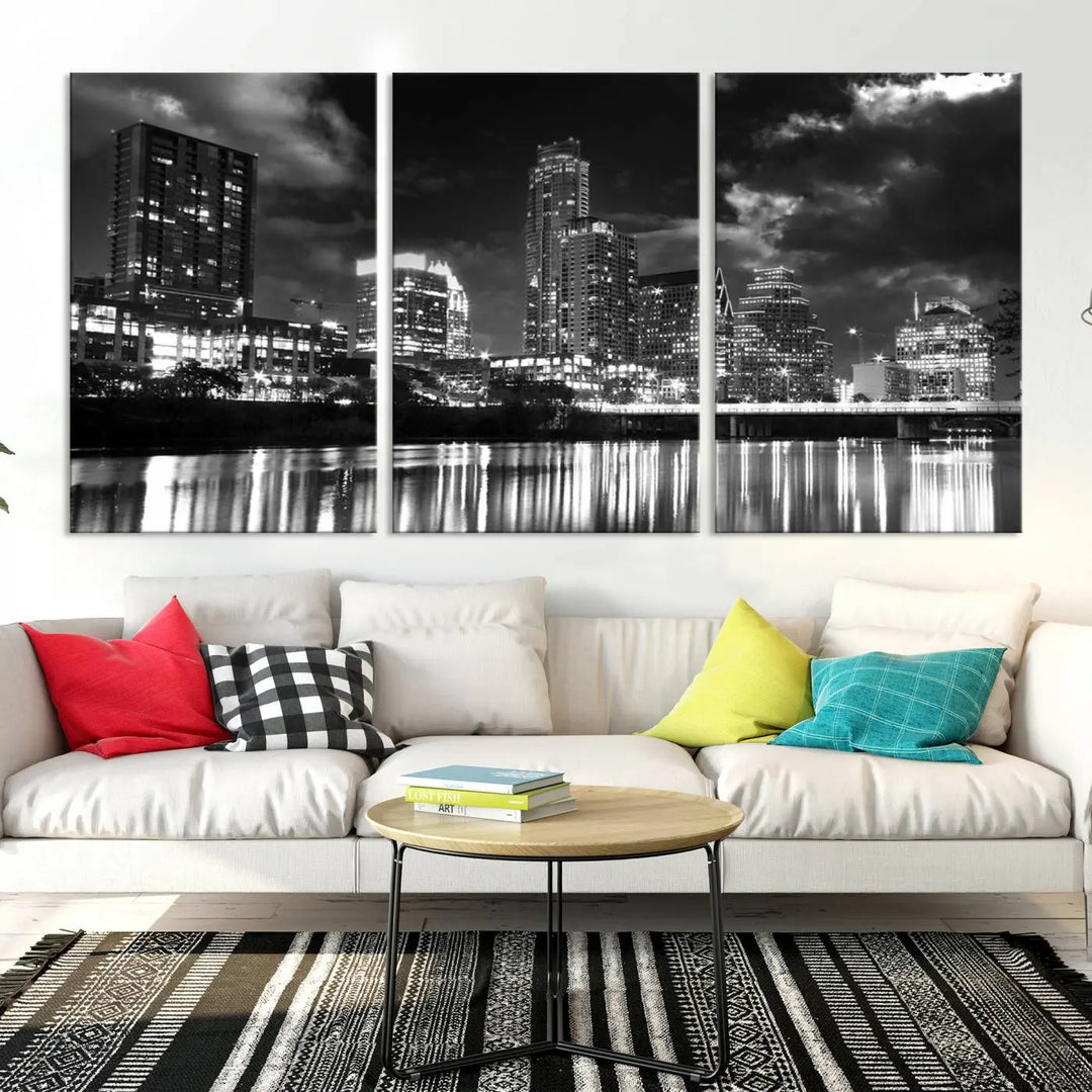 The Austin City Lights Cloudy Skyline Black and White Wall Art Cityscape Canvas Print is a large triptych that showcases illuminated city buildings reflected in water at night. This artwork is produced on museum-quality canvases with a UV-protective coating, ensuring its vibrancy and longevity for years to come.