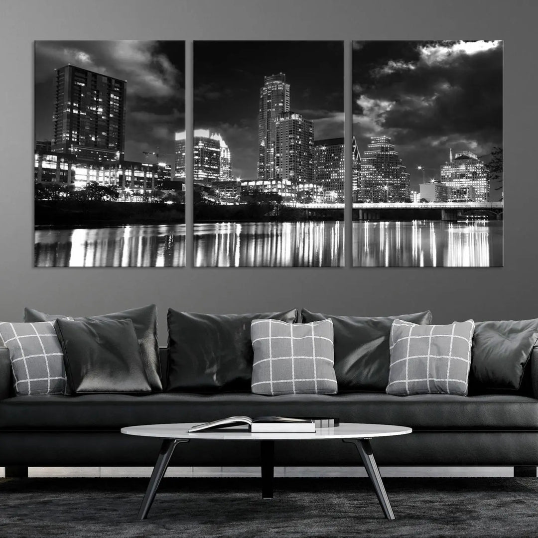 The Austin City Lights Cloudy Skyline Black and White Wall Art Cityscape Canvas Print is a large triptych that showcases illuminated city buildings reflected in water at night. This artwork is produced on museum-quality canvases with a UV-protective coating, ensuring its vibrancy and longevity for years to come.