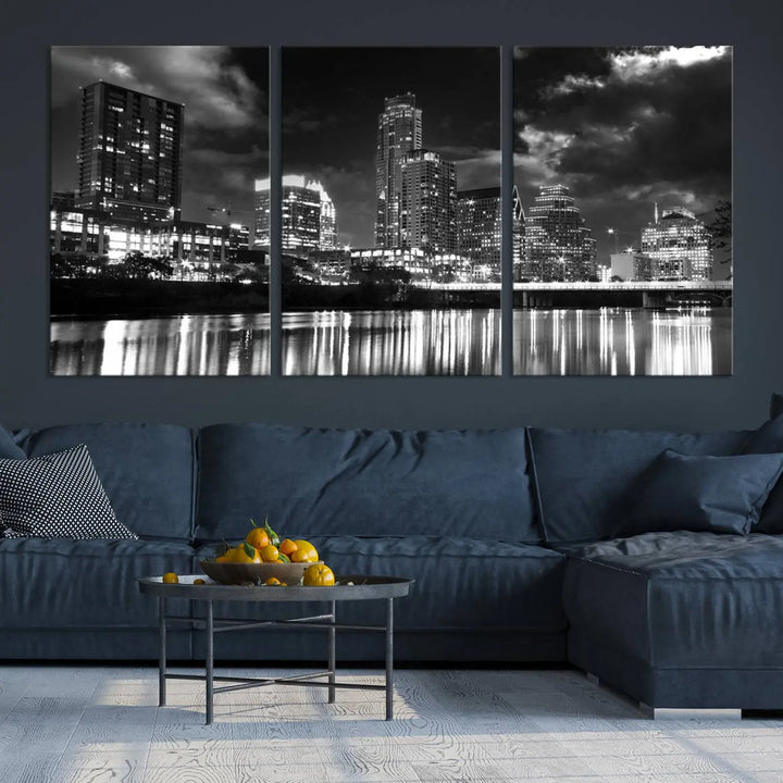 The Austin City Lights Cloudy Skyline Black and White Wall Art Cityscape Canvas Print is a large triptych that showcases illuminated city buildings reflected in water at night. This artwork is produced on museum-quality canvases with a UV-protective coating, ensuring its vibrancy and longevity for years to come.