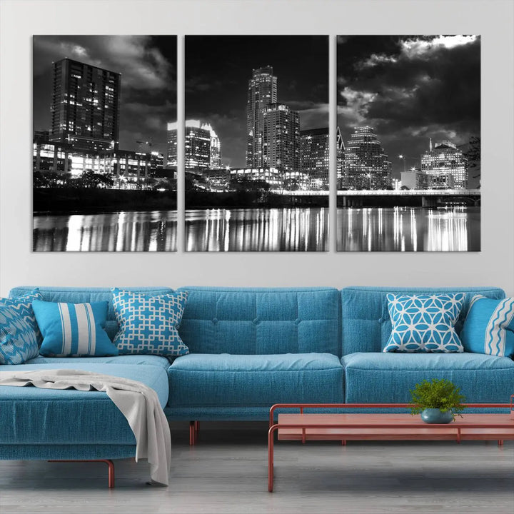 The Austin City Lights Cloudy Skyline Black and White Wall Art Cityscape Canvas Print is a large triptych that showcases illuminated city buildings reflected in water at night. This artwork is produced on museum-quality canvases with a UV-protective coating, ensuring its vibrancy and longevity for years to come.