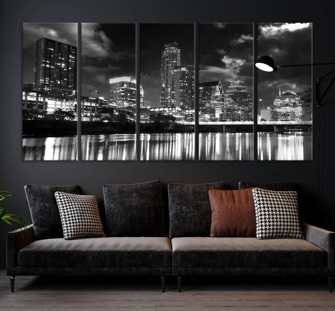 The Austin City Lights Cloudy Skyline Black and White Wall Art Cityscape Canvas Print is a large triptych that showcases illuminated city buildings reflected in water at night. This artwork is produced on museum-quality canvases with a UV-protective coating, ensuring its vibrancy and longevity for years to come.