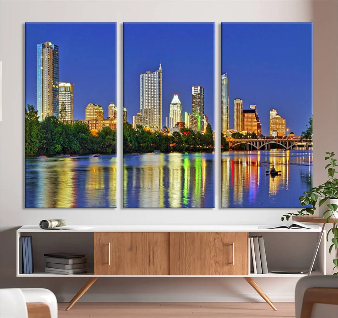 Austin City Lights Skyline Cityscape View Wall Art Canvas Print showcases a stunning triptych of a city skyline at night, featuring the reflection of illuminated buildings on a river. Made with museum-quality polycotton and finished with a UV-protective coating, it is ready to hang and instantly elevate your space.