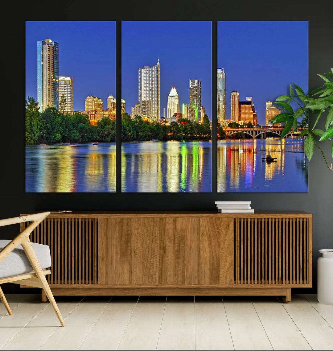 Austin City Lights Skyline Cityscape View Wall Art Canvas Print showcases a stunning triptych of a city skyline at night, featuring the reflection of illuminated buildings on a river. Made with museum-quality polycotton and finished with a UV-protective coating, it is ready to hang and instantly elevate your space.