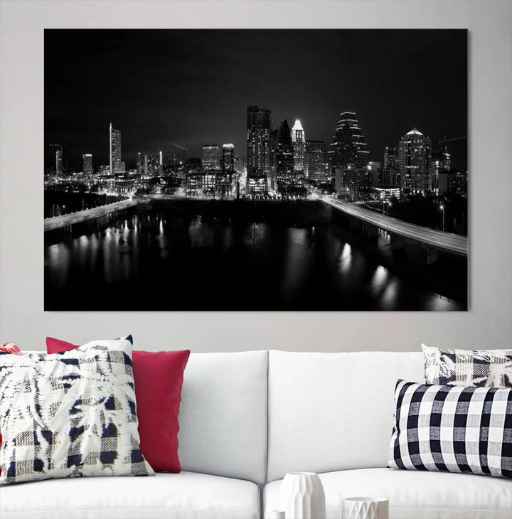 The Austin City Skyline Black and White Wall Art Cityscape Canvas Print, a stunning triptych of a nighttime cityscape printed on museum-quality canvases, adorns the wall. This hand-assembled framed artwork exudes elegance and features a UV-protective coating to maintain the city's captivating allure.