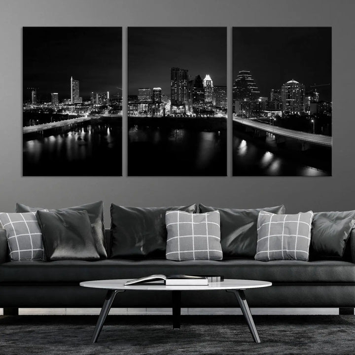 The Austin City Skyline Black and White Wall Art Cityscape Canvas Print, a stunning triptych of a nighttime cityscape printed on museum-quality canvases, adorns the wall. This hand-assembled framed artwork exudes elegance and features a UV-protective coating to maintain the city's captivating allure.