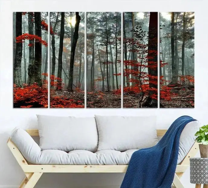 The Autumn Forest Canvas Wall Art showcases an enchanting triptych print of a foggy forest adorned with vibrant red leaves, offering nature-inspired wall art at its finest.