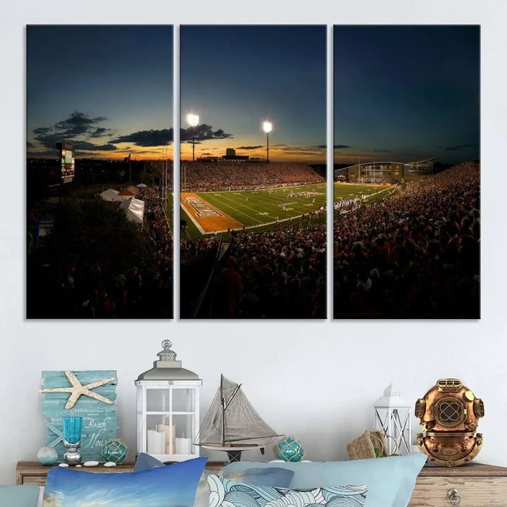 Experience the vibrant energy of game day with the Ball State Cardinals Football Team Print - Muncie Scheumann Stadium Wall Art Canvas Print. This stunning artwork captures a sunset-lit football stadium, alive with a match in progress and spectators filling the stands under floodlights, all rendered on museum-quality canvas.