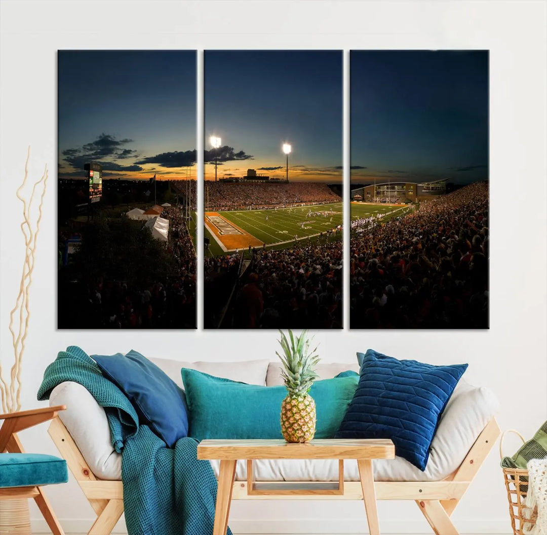 Experience the vibrant energy of game day with the Ball State Cardinals Football Team Print - Muncie Scheumann Stadium Wall Art Canvas Print. This stunning artwork captures a sunset-lit football stadium, alive with a match in progress and spectators filling the stands under floodlights, all rendered on museum-quality canvas.