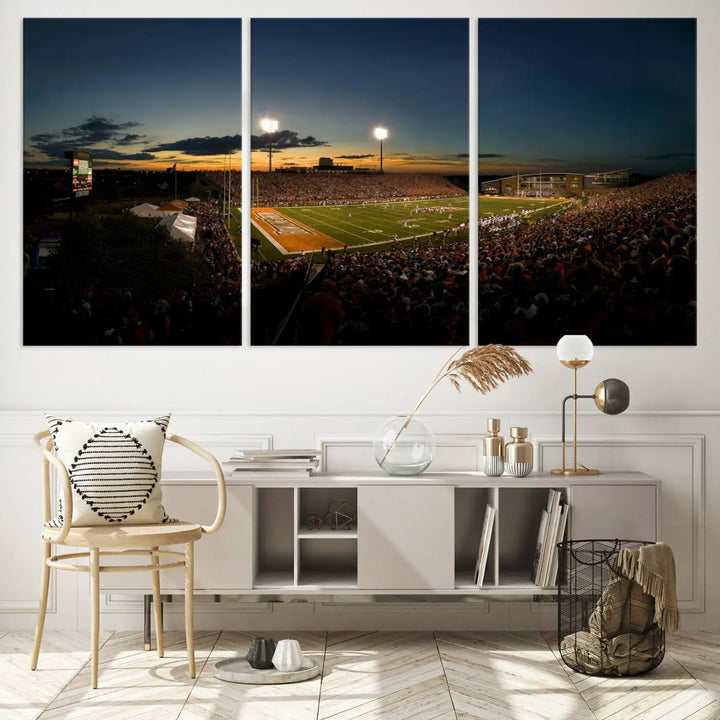 Experience the vibrant energy of game day with the Ball State Cardinals Football Team Print - Muncie Scheumann Stadium Wall Art Canvas Print. This stunning artwork captures a sunset-lit football stadium, alive with a match in progress and spectators filling the stands under floodlights, all rendered on museum-quality canvas.