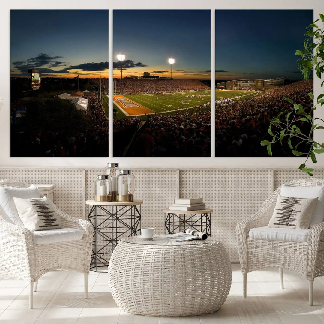 Experience the vibrant energy of game day with the Ball State Cardinals Football Team Print - Muncie Scheumann Stadium Wall Art Canvas Print. This stunning artwork captures a sunset-lit football stadium, alive with a match in progress and spectators filling the stands under floodlights, all rendered on museum-quality canvas.