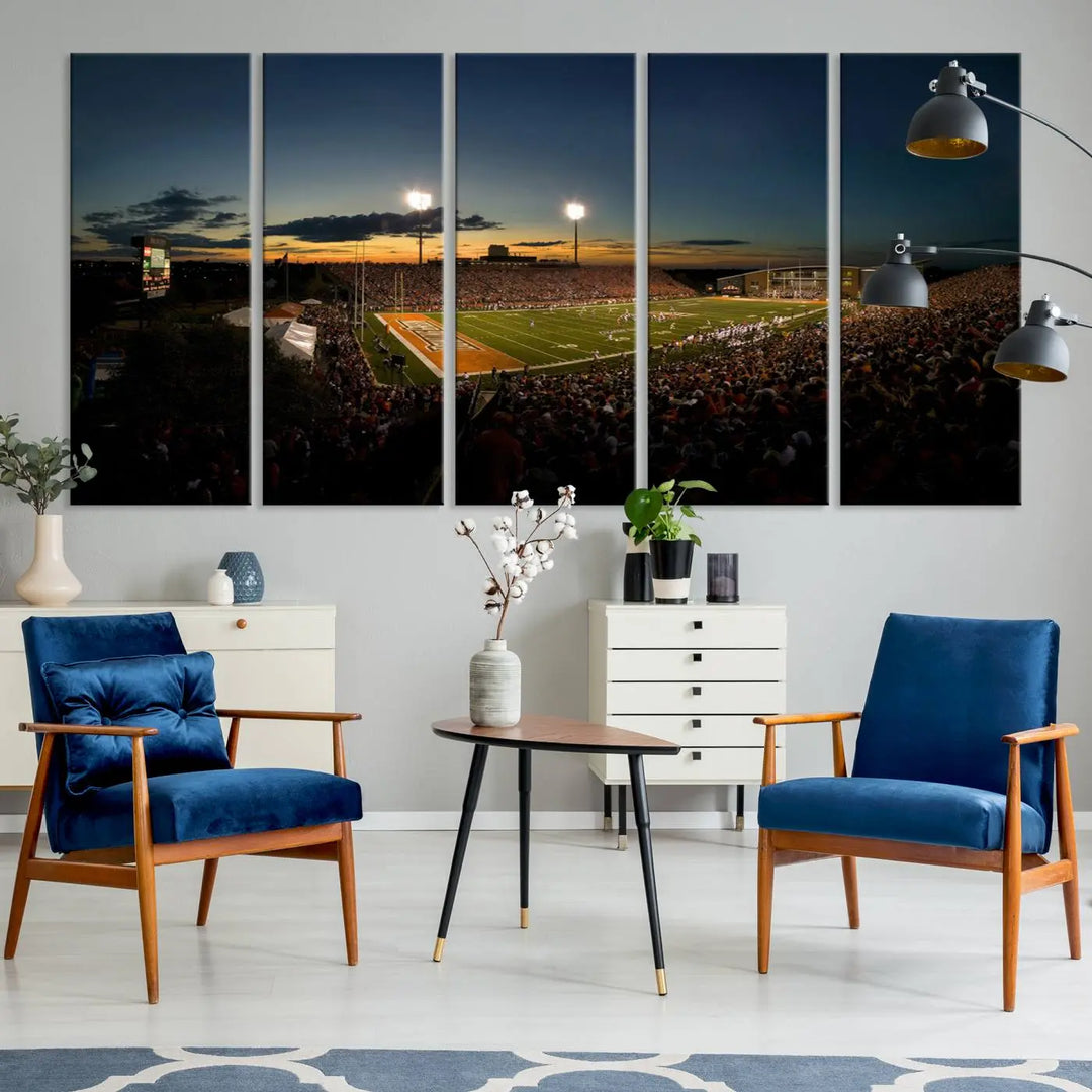 Experience the vibrant energy of game day with the Ball State Cardinals Football Team Print - Muncie Scheumann Stadium Wall Art Canvas Print. This stunning artwork captures a sunset-lit football stadium, alive with a match in progress and spectators filling the stands under floodlights, all rendered on museum-quality canvas.