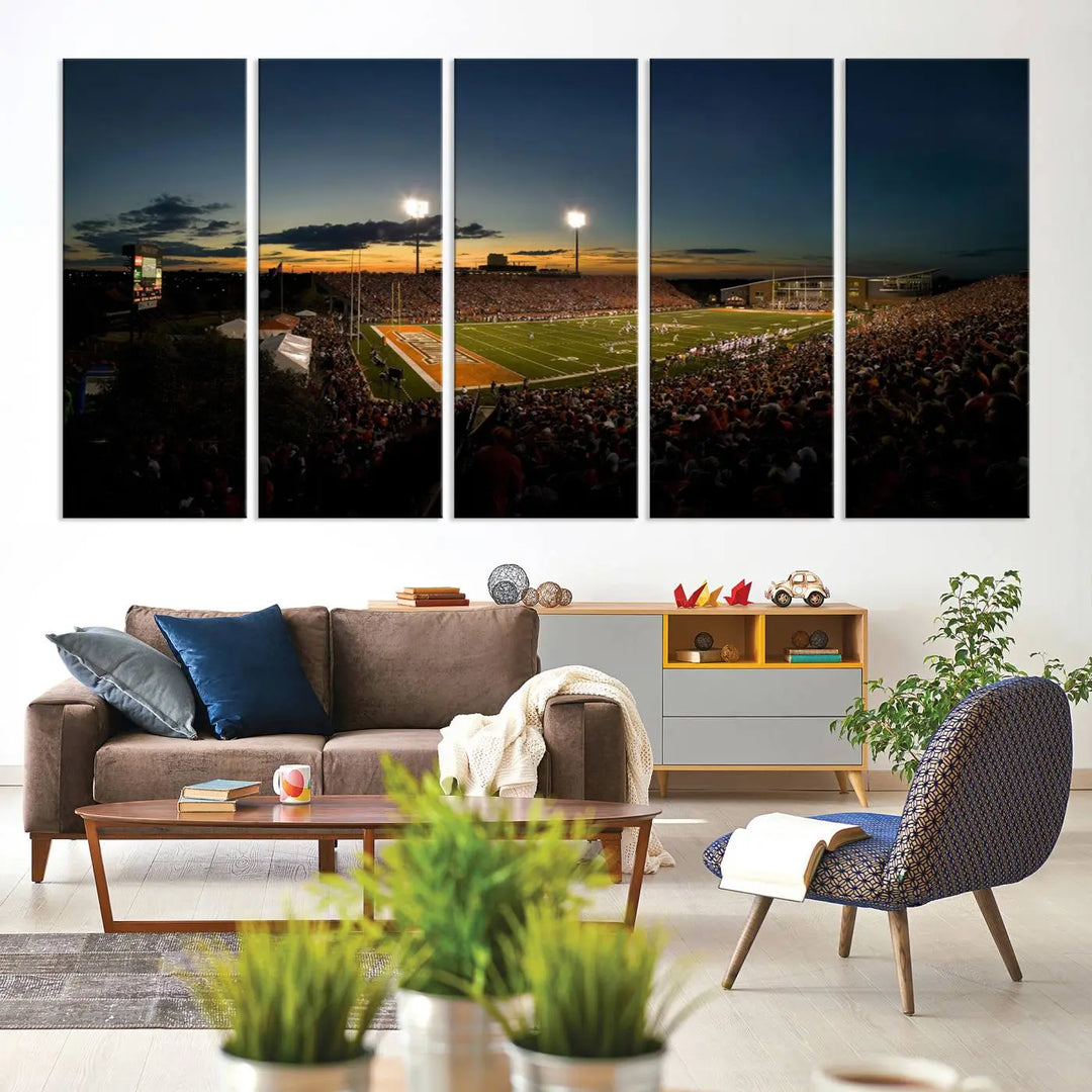 Experience the vibrant energy of game day with the Ball State Cardinals Football Team Print - Muncie Scheumann Stadium Wall Art Canvas Print. This stunning artwork captures a sunset-lit football stadium, alive with a match in progress and spectators filling the stands under floodlights, all rendered on museum-quality canvas.