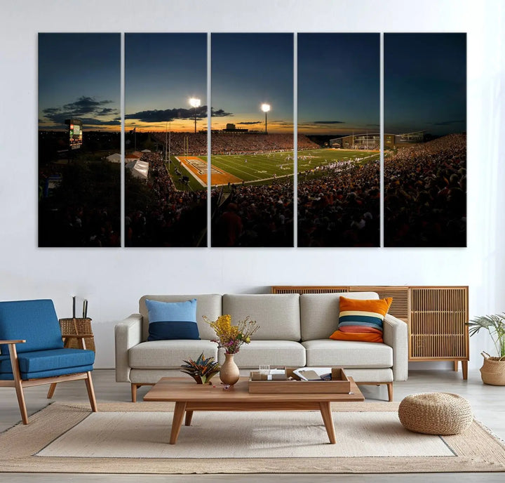 Experience the vibrant energy of game day with the Ball State Cardinals Football Team Print - Muncie Scheumann Stadium Wall Art Canvas Print. This stunning artwork captures a sunset-lit football stadium, alive with a match in progress and spectators filling the stands under floodlights, all rendered on museum-quality canvas.