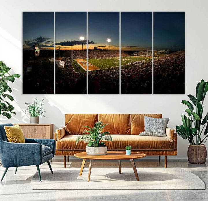 Experience the vibrant energy of game day with the Ball State Cardinals Football Team Print - Muncie Scheumann Stadium Wall Art Canvas Print. This stunning artwork captures a sunset-lit football stadium, alive with a match in progress and spectators filling the stands under floodlights, all rendered on museum-quality canvas.