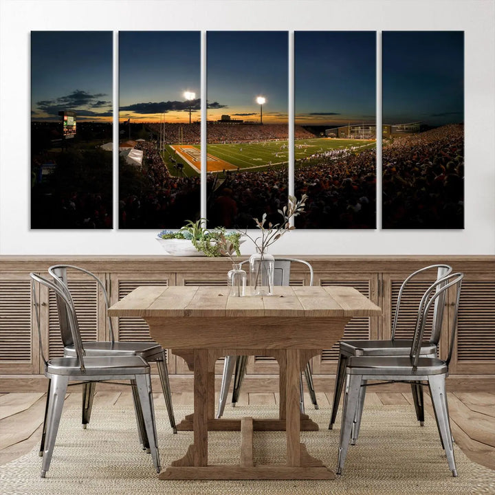 Experience the vibrant energy of game day with the Ball State Cardinals Football Team Print - Muncie Scheumann Stadium Wall Art Canvas Print. This stunning artwork captures a sunset-lit football stadium, alive with a match in progress and spectators filling the stands under floodlights, all rendered on museum-quality canvas.