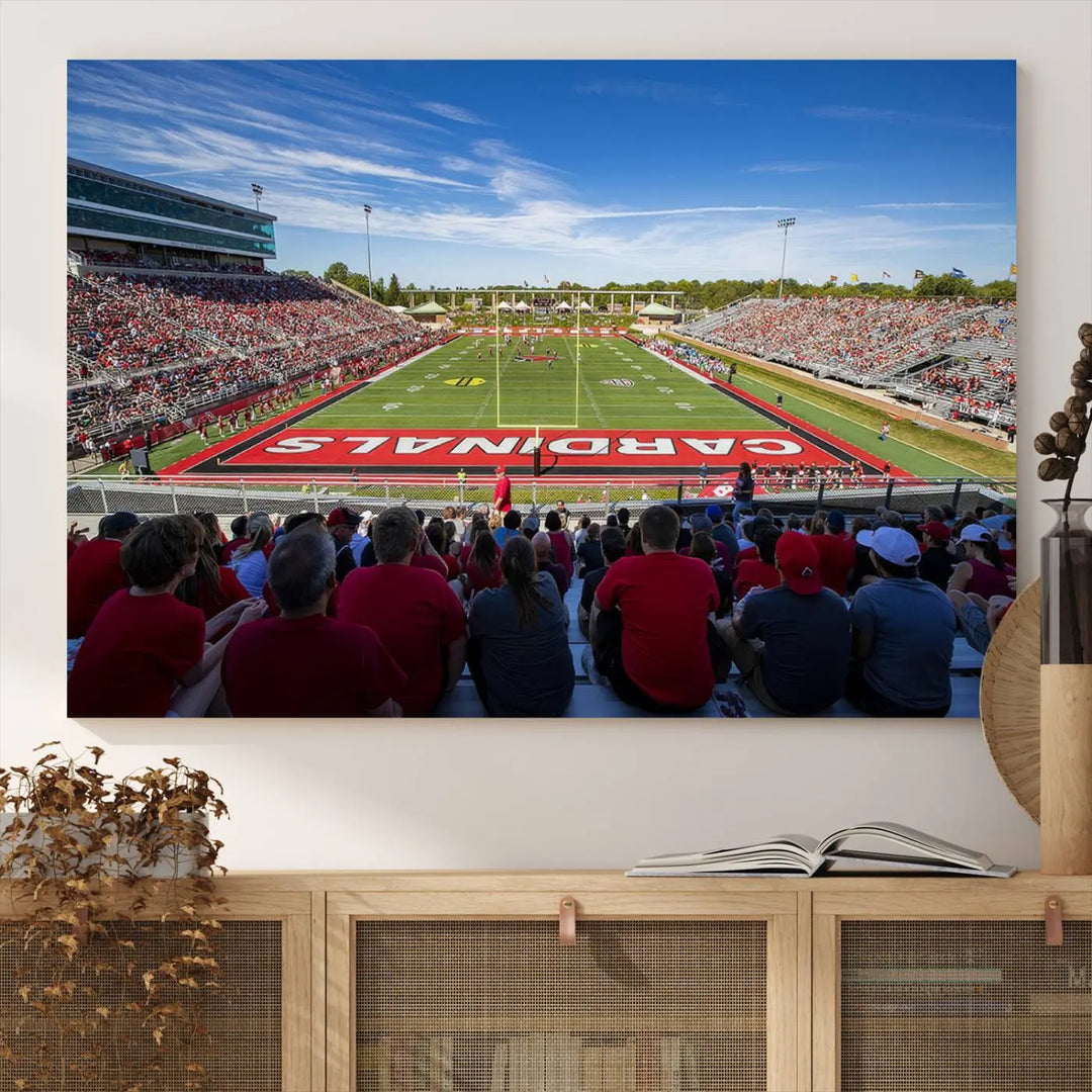 Experience a gallery-quality finish with the Ball State Cardinals Football Team Print - Muncie Scheumann Stadium Wall Art Canvas Print. This piece features a three-panel depiction of the stadium and its lively crowd from the stands, adding a dynamic touch to any modern living room setting.