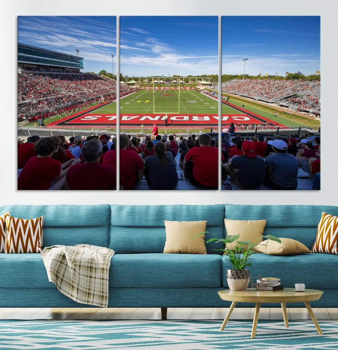 Experience a gallery-quality finish with the Ball State Cardinals Football Team Print - Muncie Scheumann Stadium Wall Art Canvas Print. This piece features a three-panel depiction of the stadium and its lively crowd from the stands, adding a dynamic touch to any modern living room setting.