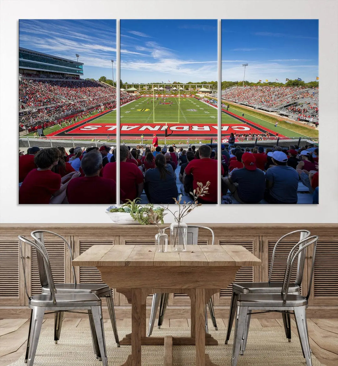 Experience a gallery-quality finish with the Ball State Cardinals Football Team Print - Muncie Scheumann Stadium Wall Art Canvas Print. This piece features a three-panel depiction of the stadium and its lively crowd from the stands, adding a dynamic touch to any modern living room setting.