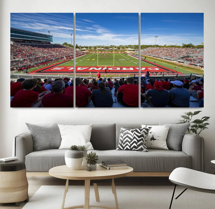 Experience a gallery-quality finish with the Ball State Cardinals Football Team Print - Muncie Scheumann Stadium Wall Art Canvas Print. This piece features a three-panel depiction of the stadium and its lively crowd from the stands, adding a dynamic touch to any modern living room setting.