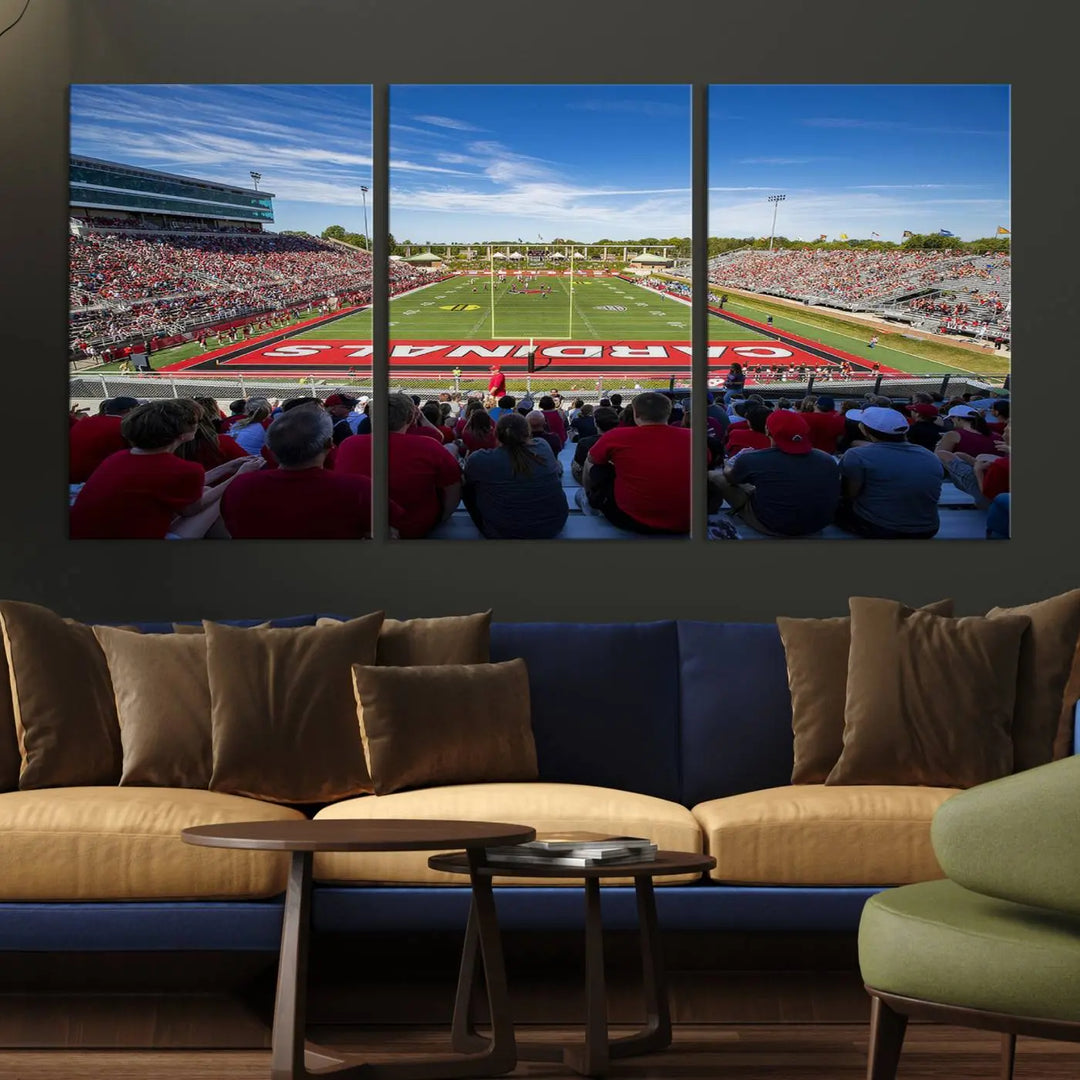 Experience a gallery-quality finish with the Ball State Cardinals Football Team Print - Muncie Scheumann Stadium Wall Art Canvas Print. This piece features a three-panel depiction of the stadium and its lively crowd from the stands, adding a dynamic touch to any modern living room setting.