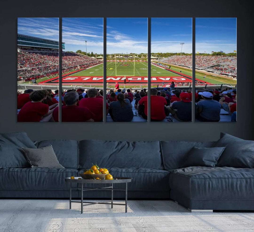 Experience a gallery-quality finish with the Ball State Cardinals Football Team Print - Muncie Scheumann Stadium Wall Art Canvas Print. This piece features a three-panel depiction of the stadium and its lively crowd from the stands, adding a dynamic touch to any modern living room setting.