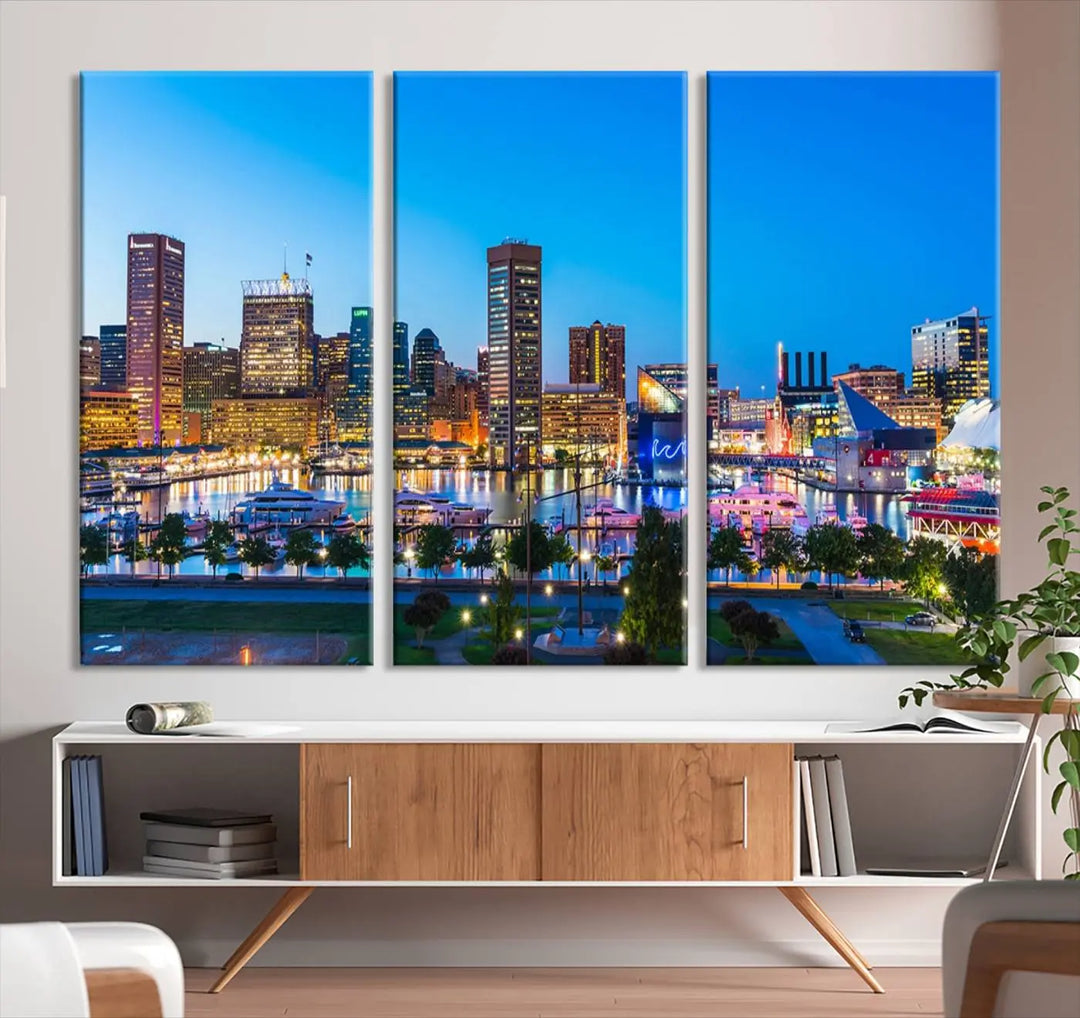 The Baltimore City Lights Blue Skyline Cityscape View Wall Art Canvas Print, a three-panel depiction of a city skyline at dusk on museum-quality canvas, adorns the area, showcasing an elegant evening cityscape.