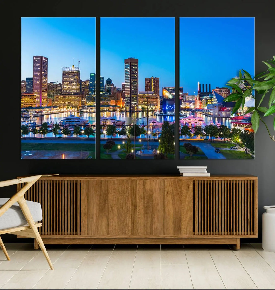 The Baltimore City Lights Blue Skyline Cityscape View Wall Art Canvas Print, a three-panel depiction of a city skyline at dusk on museum-quality canvas, adorns the area, showcasing an elegant evening cityscape.